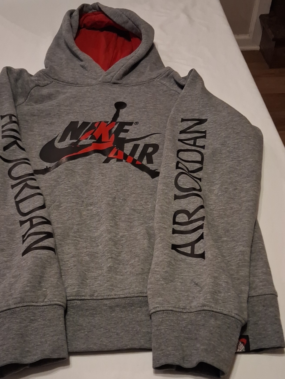 Nike Gray Pullover Hoodie with Red Lined Hood and Black Graphics